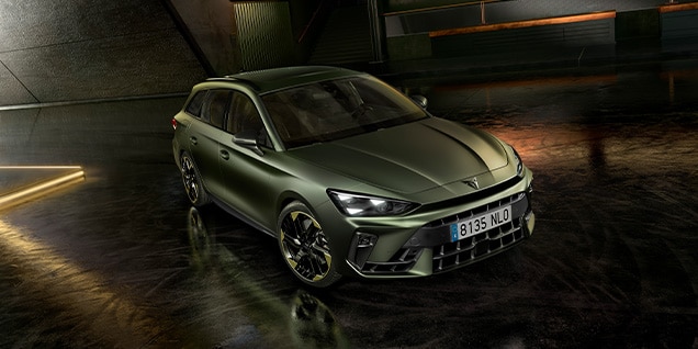 CUPRA Leon SP, Tribe Edition, in matte green parked indoors with modern ambient lighting and an industrial-style background.