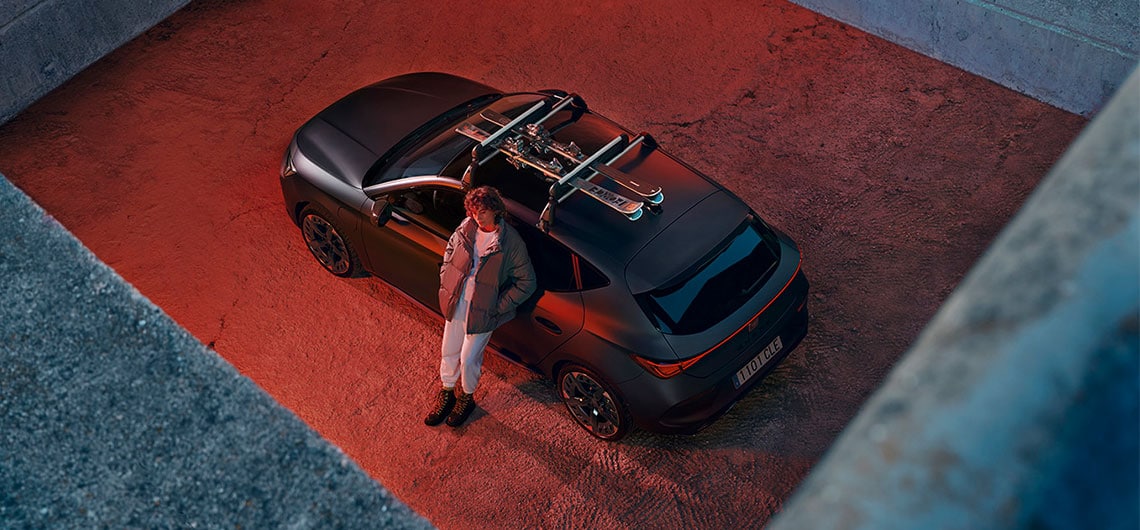 alexia putellas sitting in front of black cupra formentor vehicle