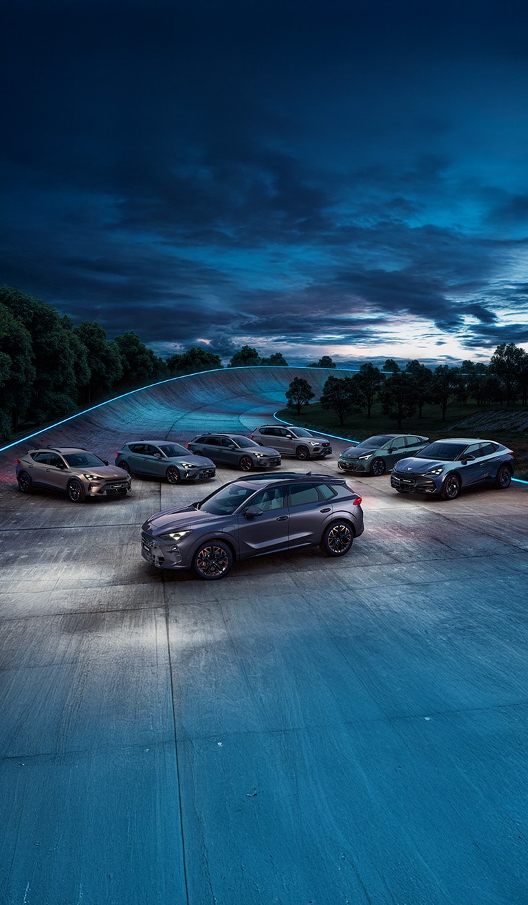 A person intently looking at their smartphone, standing outdoors with blurred modern city buildings and a bright sunset sky in the background.